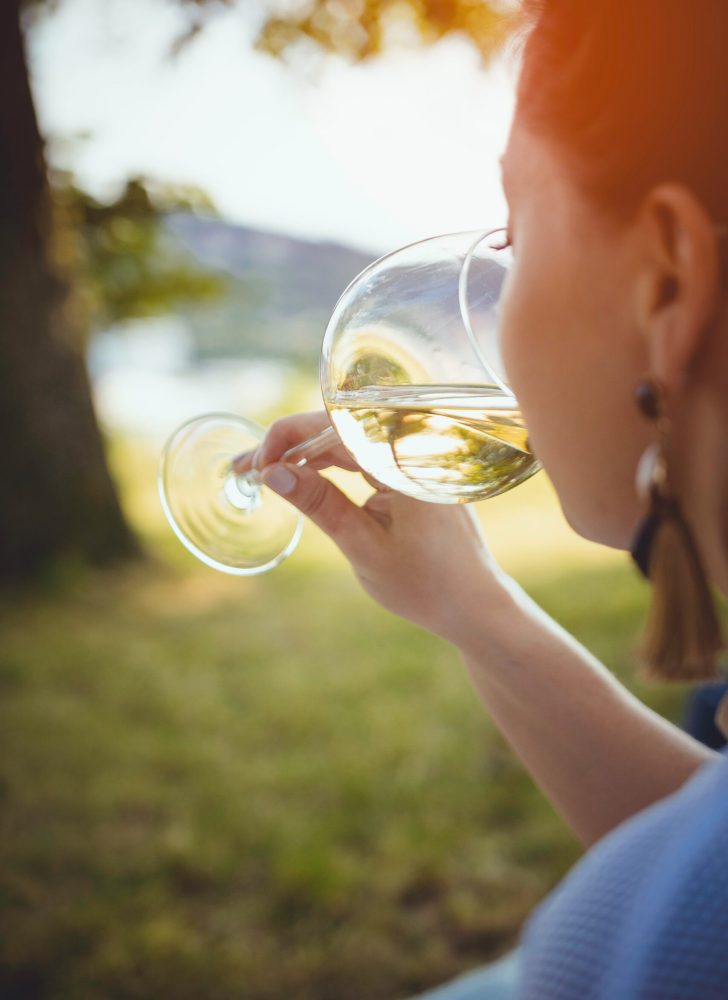 Woman tasting wine outdoors Woman tasting wine outdoors