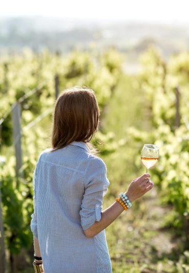 Woman tasting wine outdoors