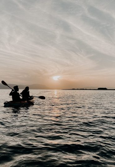 Canoeing on lake during sunset
